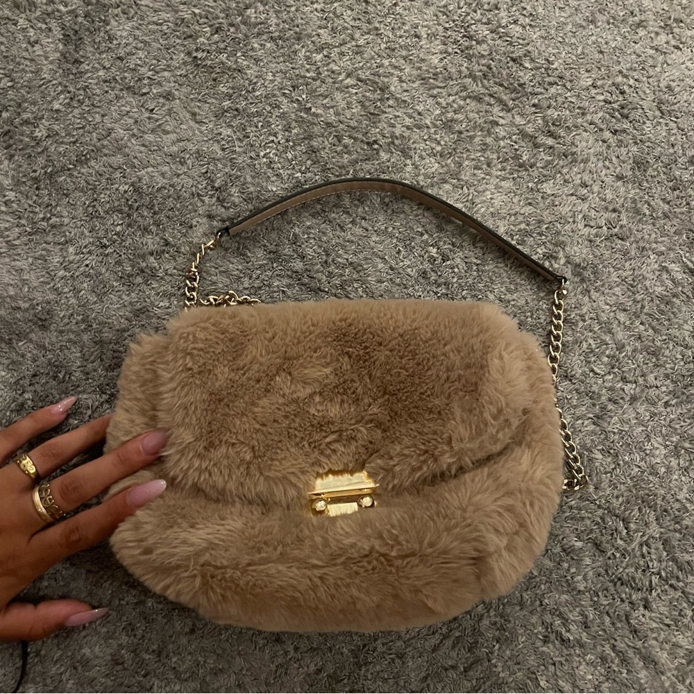 Fluffy purse with gold chain.